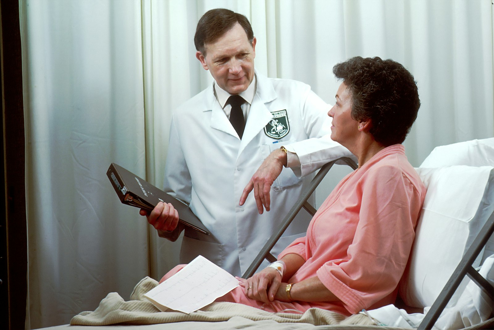 Pediatrician examining a smiling child during a wellness visit